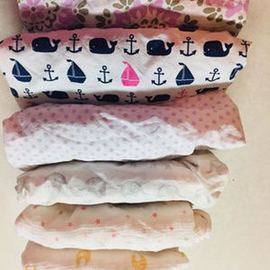 Six crib sheets and two waterproof mattress covers